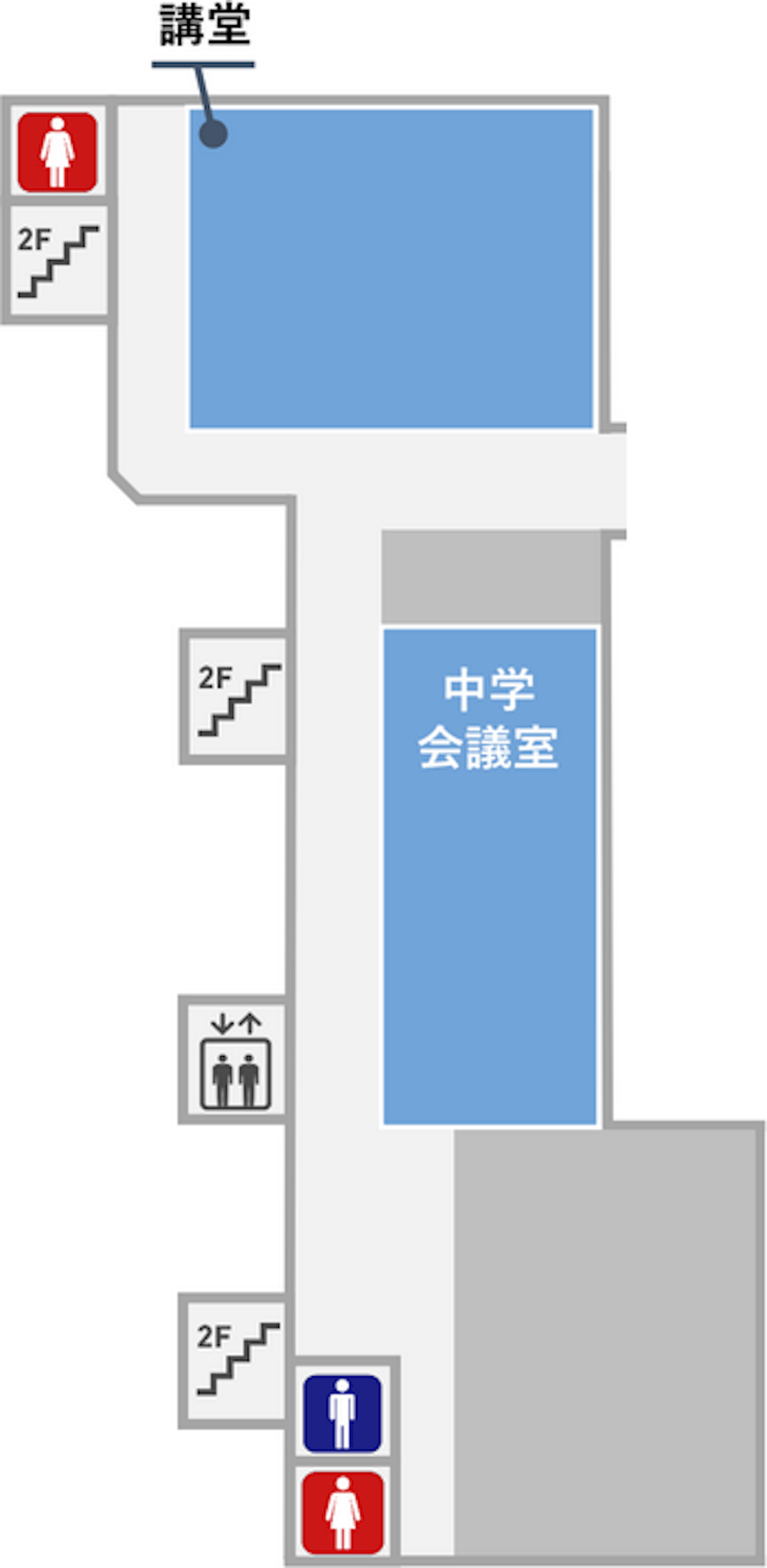 講堂の隣に女子トイレがあります。講堂の反対側の奥には男子トイレと女子トイレがあります。講堂の前の廊下は本館２階と渡り廊下で繋がっています。